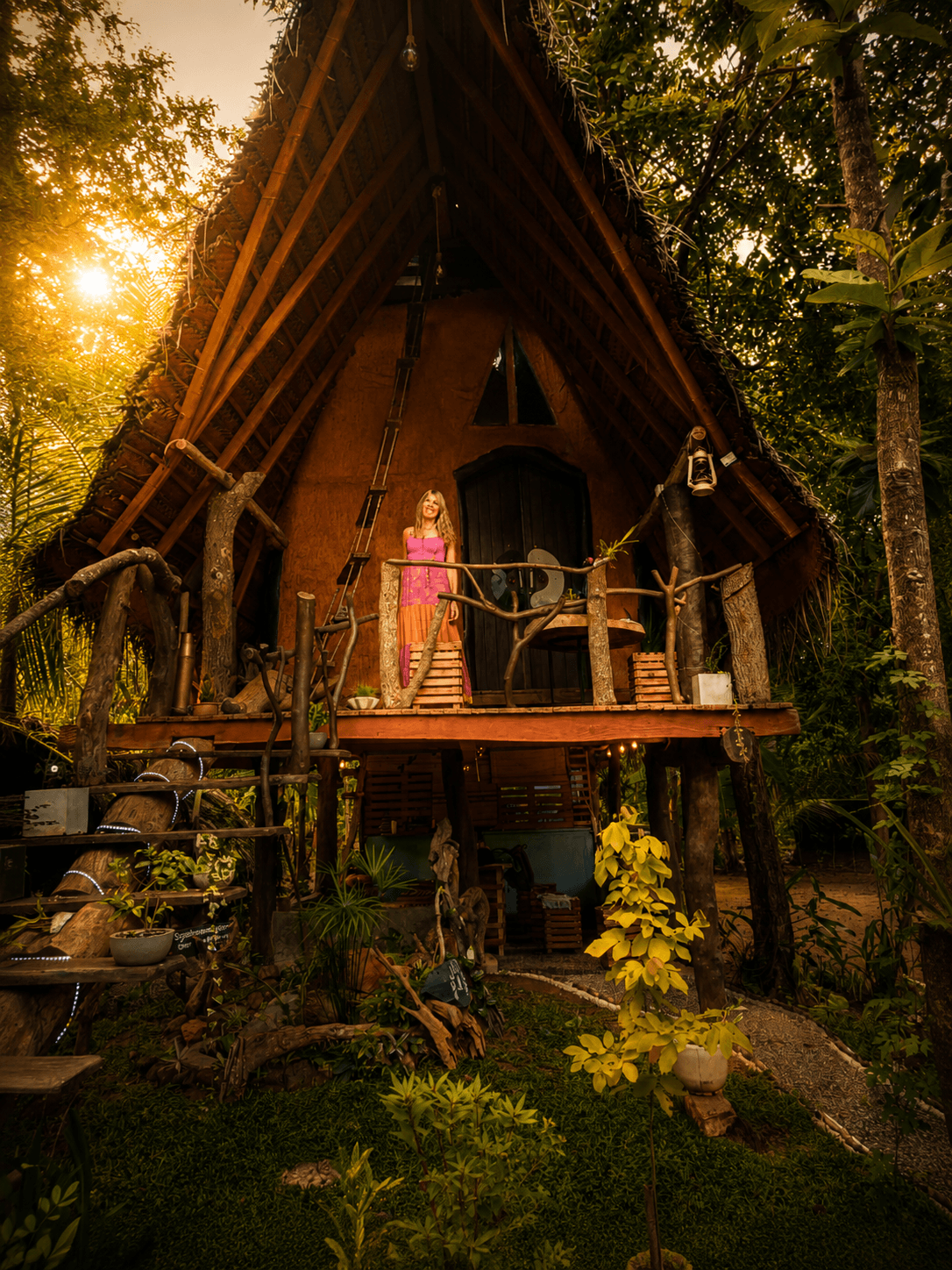Elevated wooden treehouse deck overlooking jungle canopy at sunrise
